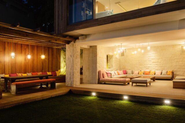 Illuminated patios with benches at night