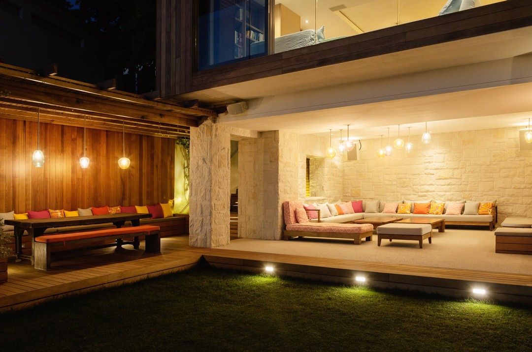 Illuminated patios with benches at night